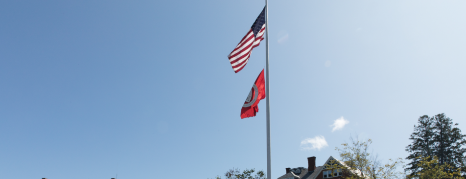 US and TAC flags fly over the New England campus